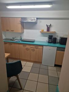 a kitchen with wooden cabinets and a blue counter top at yiggdrasil in Rostock