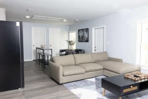 a living room with a couch and a table at 5 Min to Elon - In Unit Washer and Dryer - Fast Wi-Fi in Burlington