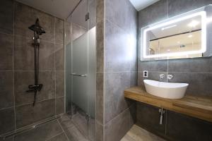 a bathroom with a sink and a shower at Avenue Hotel in Jeonju