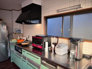 a kitchen with a counter with a blender on it at Rest Collection GuestOne Kyoto in Kyoto