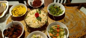 a table topped with bowls of different types of food at Mandara Holiday Home in Anuradhapura +65 photos