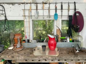 a kitchen counter with a red vase on a tray at Renovated Scanian Farmhouse With Two Studios in Skåne-Tranås