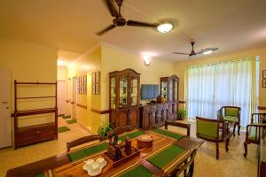 a large living room with a table and chairs at The Ferry Cross Museotel in Panaji