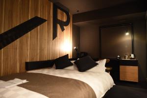 a bedroom with a bed and a night stand at Hotel Risveglio Akasaka in Tokyo