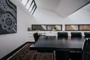 a dining room with a table and chairs at Alkina Lodge Milu in Wattle Hill