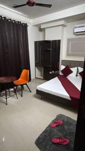 a bedroom with a bed and a table and a chair at Hotel Lavish Inn in Jāmb