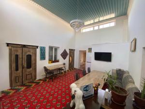 a living room with a couch and a table at Polyoz Ota in Khiva