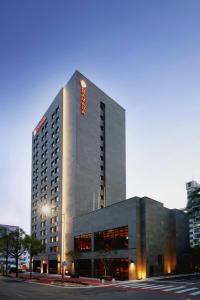 a tall building with a sign on top of it at Ramada by Wyndham Gunsan in Gunsan