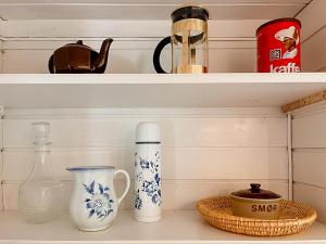 a shelf with vases and other items on it at Traditional Cabin With Sea View In Jæren in Sirevåg