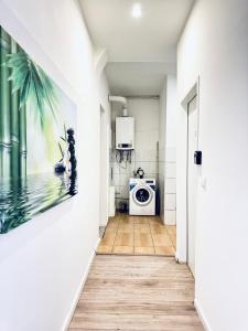 a hallway leading to a kitchen with a washing machine at Elegant 5-BR shared Home , Ideal for Groups & Families in Vienna