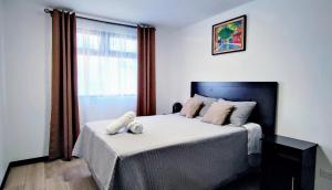 a bedroom with a large bed and a window at Alojamiento zona 12 in Boca Monte +47 photos