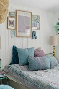 a bed with pillows on it in a room at Holiday Home With Wild Garden Near Øster Hurup in Hadsund