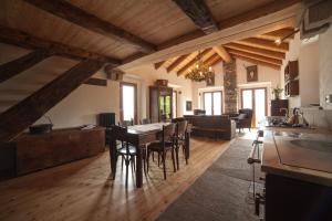 a kitchen and living room with a table and chairs at Magica Vercio in Mergozzo
