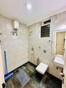 a bathroom with a toilet and a sink at Palm View 1BHK with Pool & Café - Sazo Stays in Goa