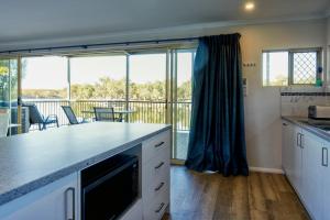 a kitchen with a view of a balcony at 42 Old Murbko Road in Morgan +23 photos