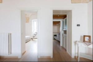 a room with white walls and a room with a hallway at Casa Vittorio Veneto in Carovigno +11 photos