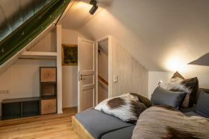 a living room with a couch and an attic at Modern Birch Chalet At Ruppberg in Zella-Mehlis