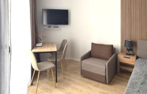 a room with a table and a chair and a television at SofiCoast in Gonio