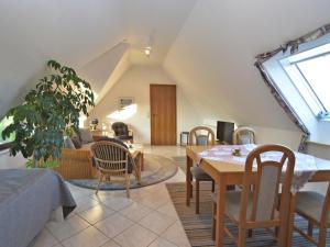 a living room with a table and chairs at Wohnung in Bad Zwesten am Edersee in Bad Zwesten