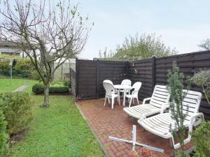 a patio with a table and chairs and a fence at Wohnung in Bad Zwesten am Edersee in Bad Zwesten