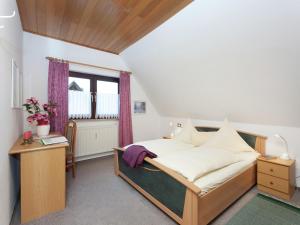 a bedroom with a bed and a table and a window at Wohnung in Bad Zwesten am Edersee in Bad Zwesten
