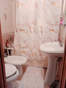 a bathroom with a toilet and a sink at 2х комнатная квартира в центре in Ustʼ-Kamenogorsk