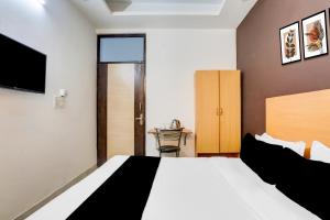 Ένα ή περισσότερα κρεβάτια σε δωμάτιο στο Super Hotel O East Punjabi Bagh Near Metro Station +27 φωτογραφίες