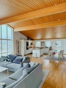 a living room with two couches and a table at Sea View Summer House In Hunnebostrand in Hunnebostrand