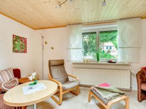 a living room with a table and a chair at Ferienwohnung im Herzen Ilsenburgs in Ilsenburg +32 photos