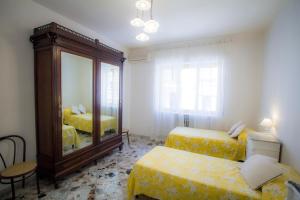 a bedroom with two beds and a mirror at Bari Grand Central Apartment in Bari