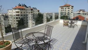a group of chairs and tables on a balcony at Lavender Boutique Hotel in Ramallah