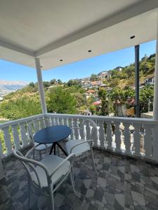 a balcony with chairs and a table and a view at Villa Marie 23 in Gjirokastër