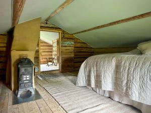 a bedroom with a bed and a wood stove at Historic Vicarage With Wood-Burning Stove in Eskilstuna