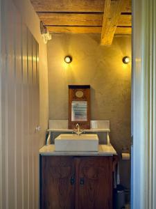 a bathroom with a sink and a mirror at Historic Vicarage With Wood-Burning Stove in Eskilstuna