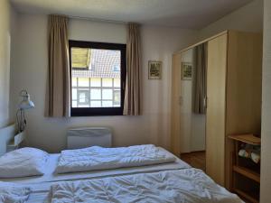 a bedroom with a white bed and a window at Wohnung in Frankenau nahe Skipisten in Frankenau