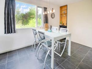 a dining room with a white table and chairs at Water Villa in Ooltgensplaat near Volkerak in Ooltgensplaat