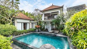 an exterior view of a villa with a swimming pool at Bendito Ubud in Ubud