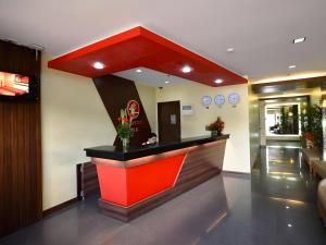 a restaurant with a red counter in a lobby at Express Inn Cebu Mabolo in Dita