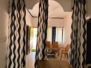 a room with a table and a dining room at MISTY MOUNT VILLA MANANTHAVADY in Mananthavady