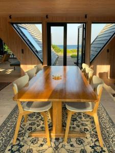a dining room with a wooden table and chairs at Architect-Designed A-House By Saksild Beach in Odder