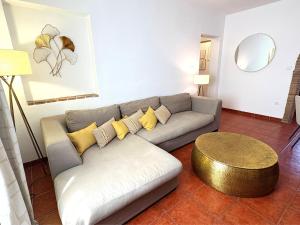 a living room with a couch and a table at XXVIII- La Casa De Las Flores in El Colmenar