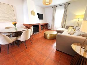 a living room with a couch and a table at XXVIII- La Casa De Las Flores in El Colmenar