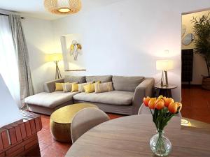 a living room with a couch and a table at XXVIII- La Casa De Las Flores in El Colmenar
