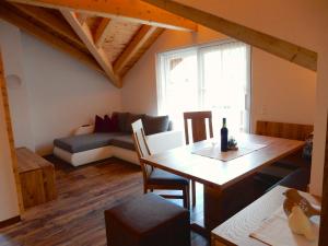 a living room with a table and a couch at Ferienwohnung Kirchschlager Zirbenholz & ruhige Lage im Ausseerland in Bad Aussee
