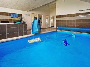 a swimming pool with a slide in the middle of it at 18 person holiday home in Hasselberg in Kappeln
