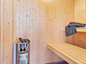 a sauna with a wooden wall and a wooden shelf at 5 star holiday home in Kappeln in Kappeln +14 photos