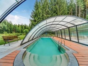 a swimming pool in a building with a tunnel at Peaceful Stay in Jägersgrün in Bad Reiboldsgrün +29 photos
