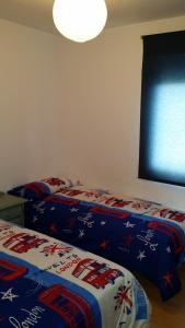 1 dormitorio con 2 camas y ventana en PISO DE 3 HABITACIONES, CON GARAJE INCLUIDO, A 1500 metros de la CATEDRAL en Santiago de Compostela