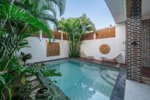 a swimming pool in the middle of a house at Luxury 3-Bedroom Pool Villa in Canggu Near Beach & Nightlife in Canggu +37 photos