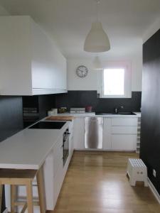 a kitchen with white cabinets and a counter top at Gwenhadu in Paimpol